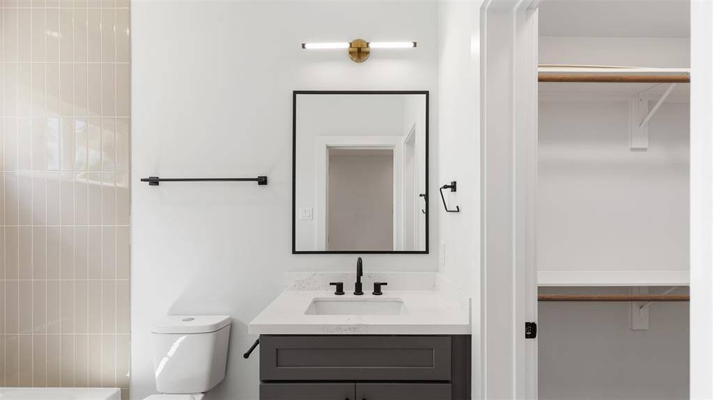 The first floor bathroom features a tub and shower combo with tile surround.