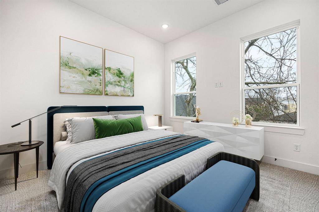 This inviting secondary bedroom offers plush carpeting, elegant recessed lighting, and expansive windows that frame stunning downtown views. Bathed in natural light, this serene space is perfect for relaxation while offering a breathtaking cityscape right from your window.