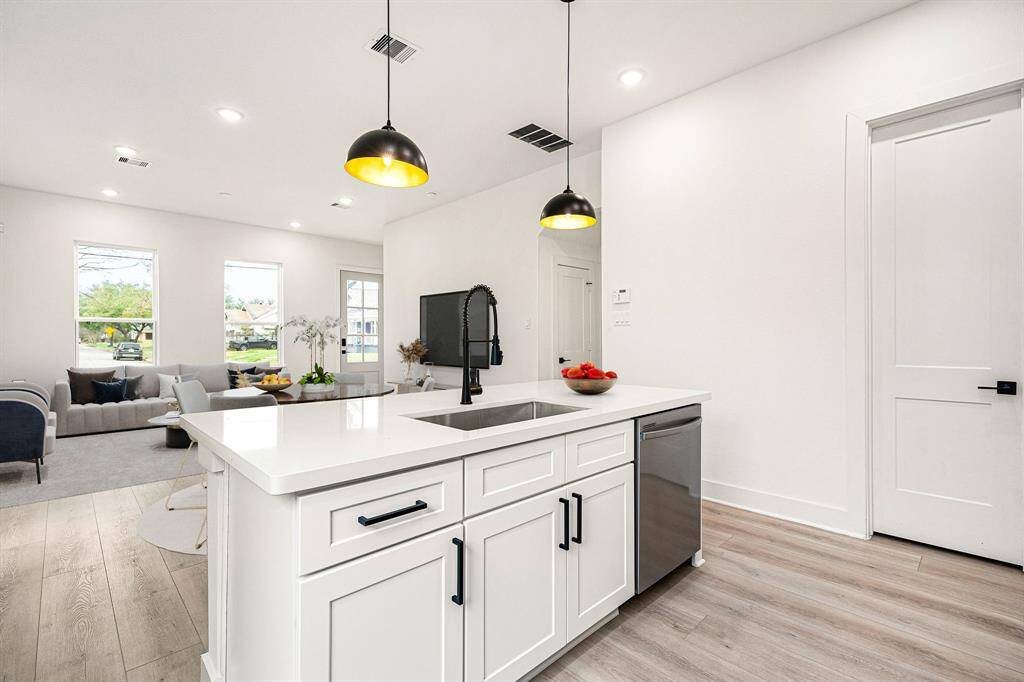 The seamless flow into the living area, complemented by large windows that flood the space with natural light, creates the perfect setting for entertaining and everyday living.