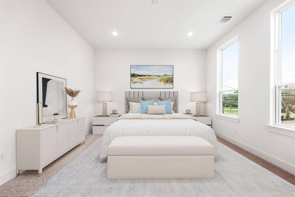 This inviting secondary bedroom offers plush carpeting, elegant recessed lighting, and expansive windows that frame stunning downtown views. Bathed in natural light, this serene space is perfect for relaxation while offering a breathtaking cityscape right from your window.