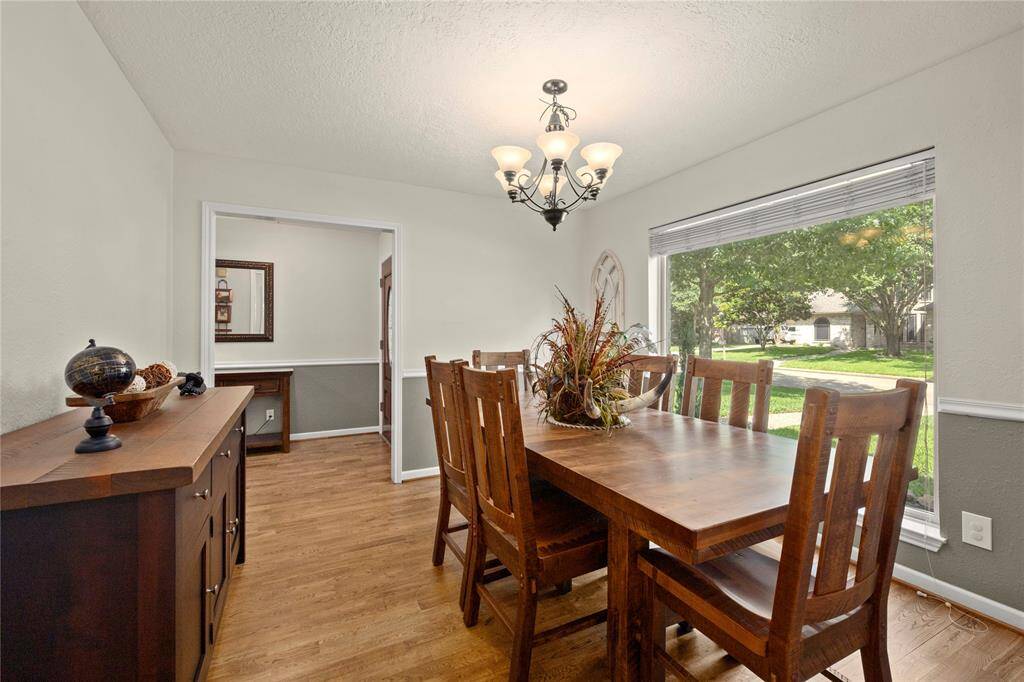 The foyer leads to this stunning dining room or to the immense family room just behind this wall. It’s not hard to imagine entertaining family and friends in this cheerful room.