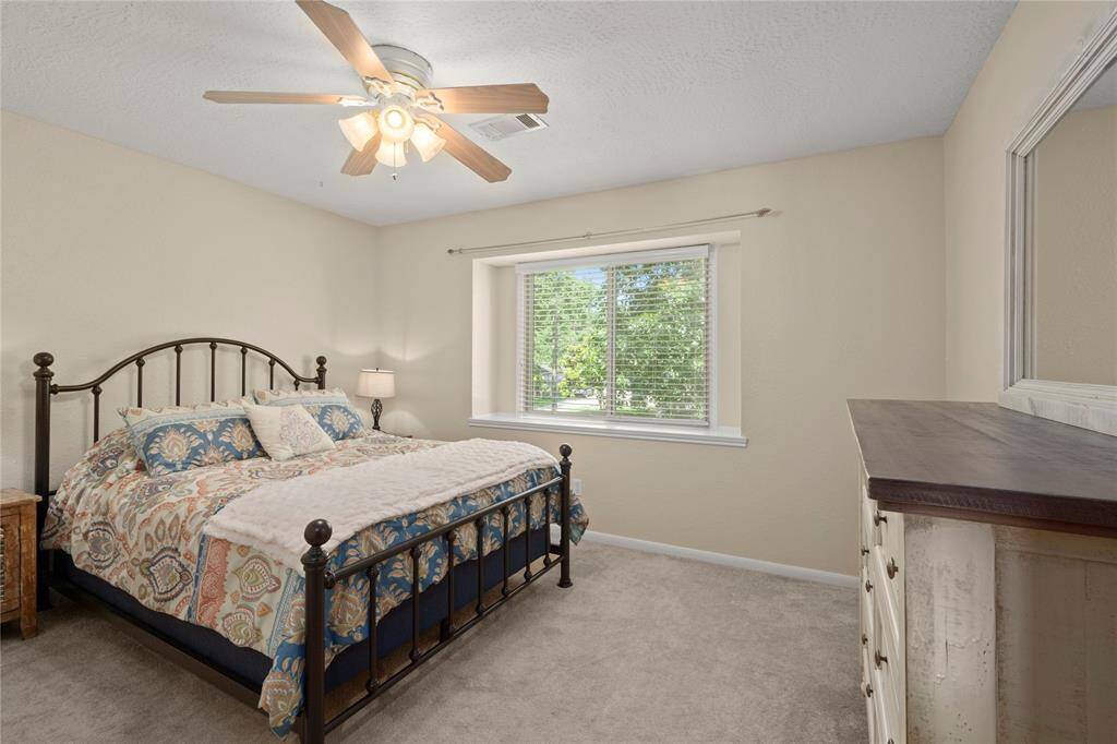 The first upstairs bedroom closest to the stairway is this lovely large room with a beautiful box window, a lighted ceiling fan and a sizeable walk-in closet.