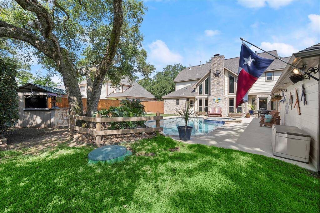 What a magnificent backyard! To the right and just behind the garage is a concrete pad that can be used to park your trailer.  This home has everything!