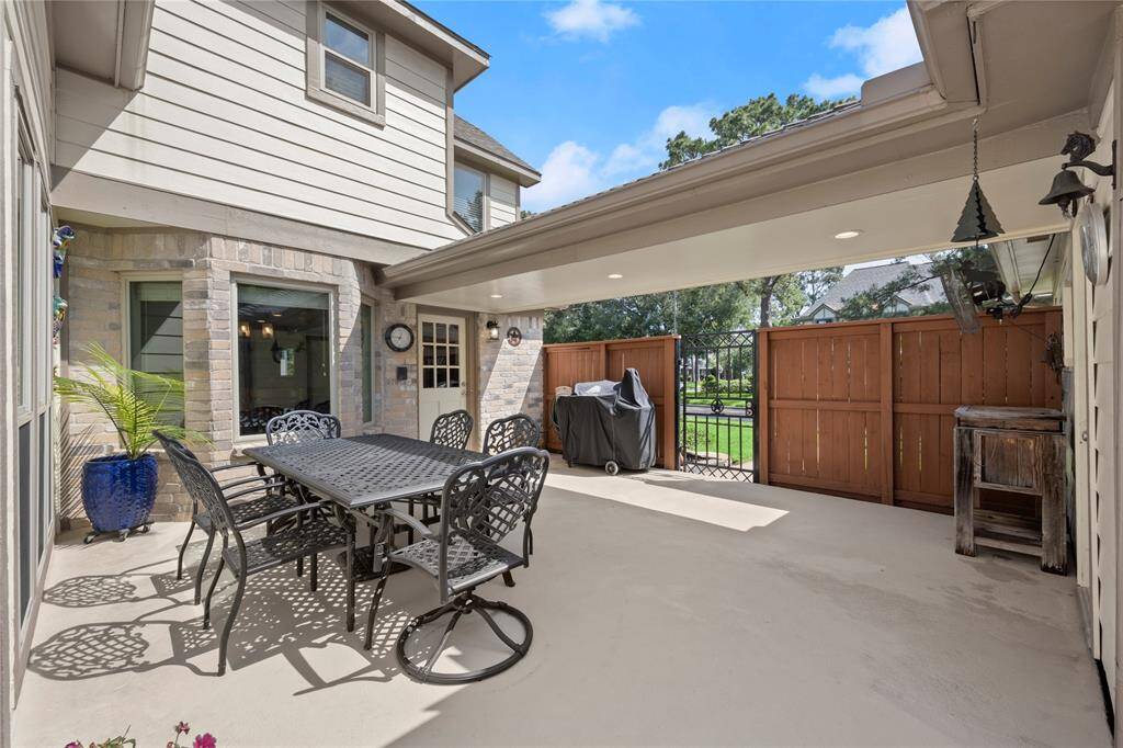 The patio is protected by this wood and wrought iron privacy fence.  Notice the recessed lighting in the breezeway.  They have thought of it all!