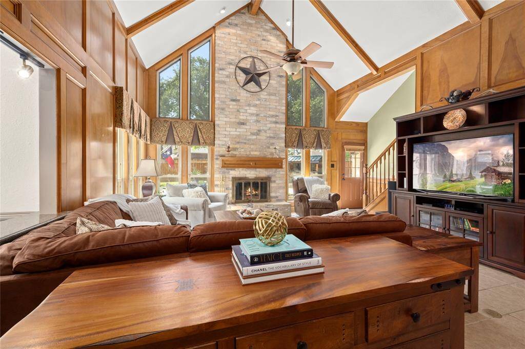 This family room is absolutely spectacular with its 18' beamed ceilings, custom block paneling, and a floor to ceiling, brick and gaslog fireplace. Eight of the eleven windows flank the fireplace surround and three wrap around to the other wall allowing you to see almost the entire backyard.