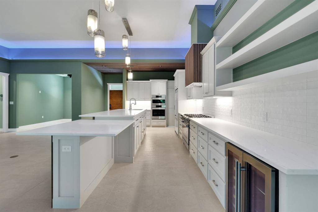 This thoughtfully designed kitchen features a drawer-style dishwasher, built-in wine fridge, and a universal layout ideal for aging in place - complemented by high-end appliances and fixtures from Bosch, Fisher & Paykel, and Kohler.