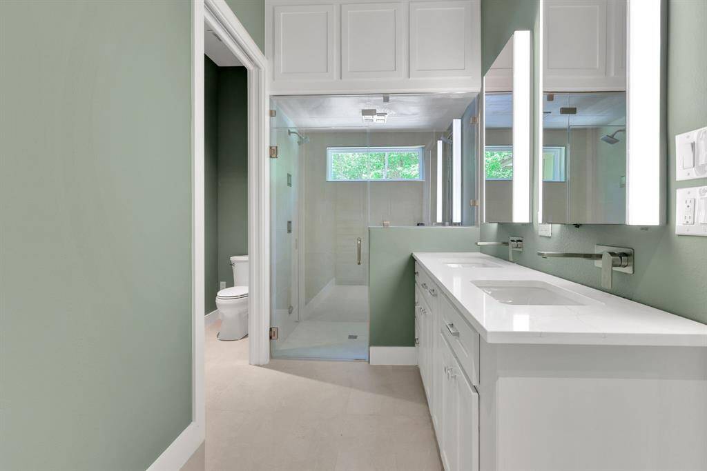 Primary bathroom with walk in shower and dual sinks