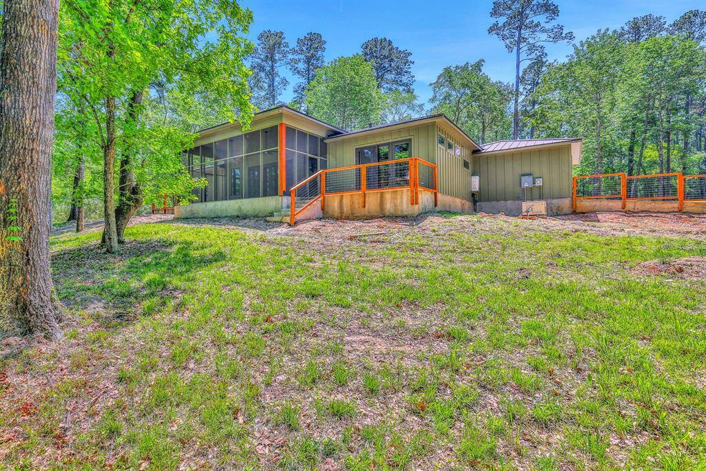Expansive backyard with wooded views and multiple outdoor living areas