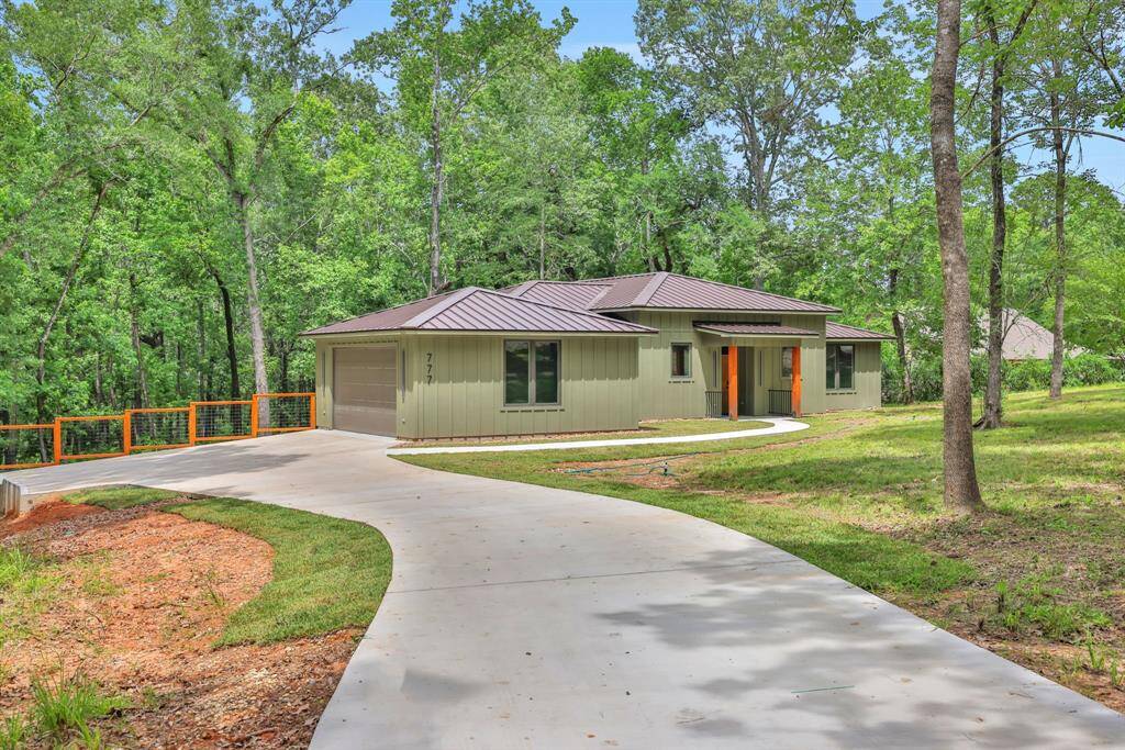 This modern retreat is set back on a winding driveway and surrounded by trees - offering both curb appeal and natural privacy.