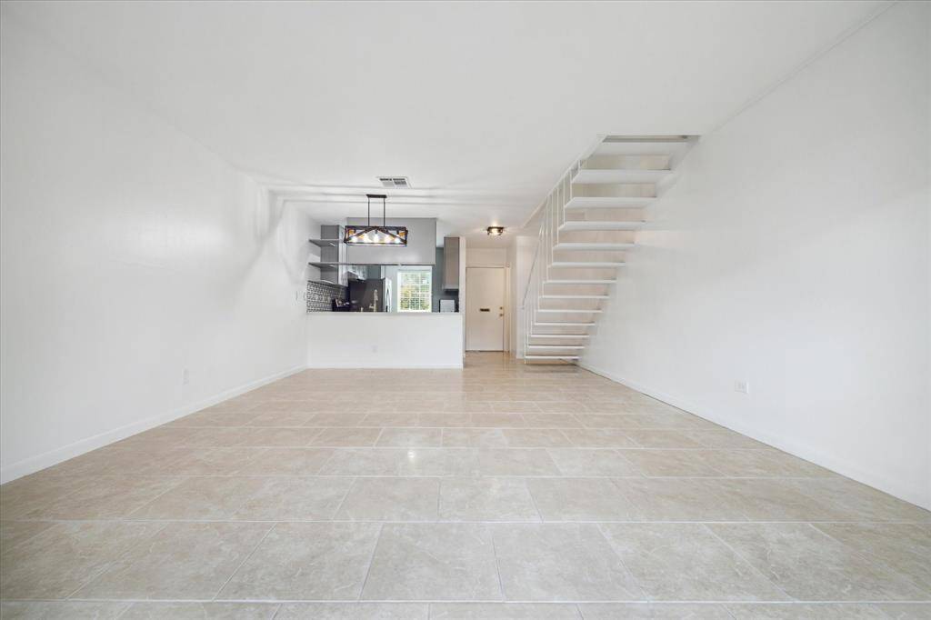 This 2-story unit features open- concept living with fresh paint and durable tile.