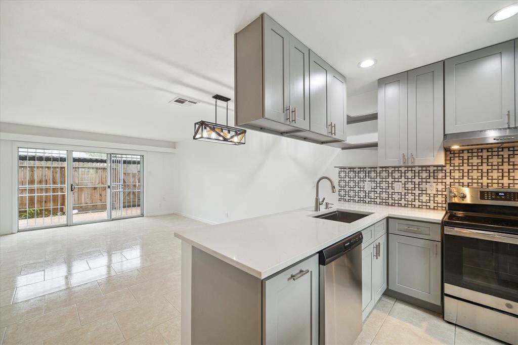 The kitchen was fully remodeled in 2021 and features quartz countertops, new plumbing, shaker style cabinets, large undermount sink, recessed lighting and dishwasher.