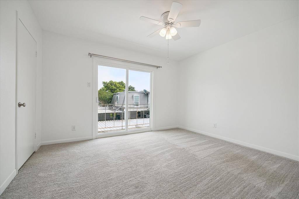 One of two bedrooms features an oversized closet with two entrances and built-in storage, a brand new ceiling fan and tons of natural light. *New carpeting has been laid that is slightly darker than when photo was taken.
