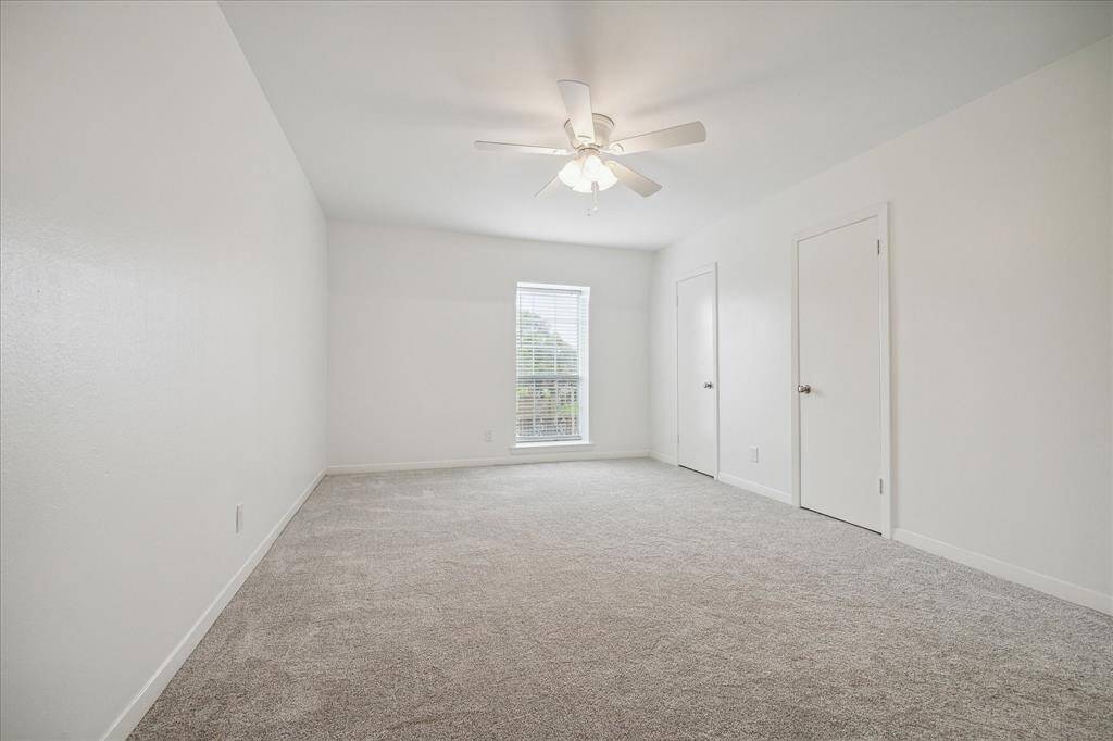 This bedroom features separate closets with recessed lighting. *New carpeting has been laid that is slightly darker than when photo was taken.