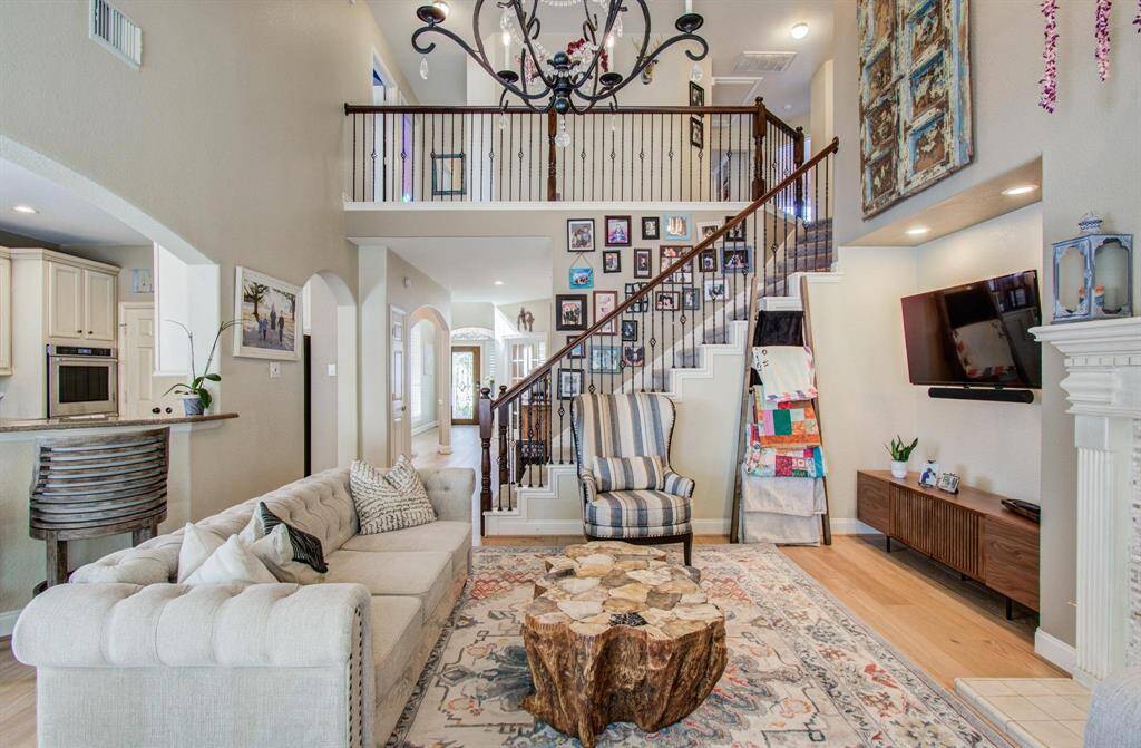 Another view of this incredible family room with open staircase to 4 bedrooms and game room upstairs with two full bathrooms up.