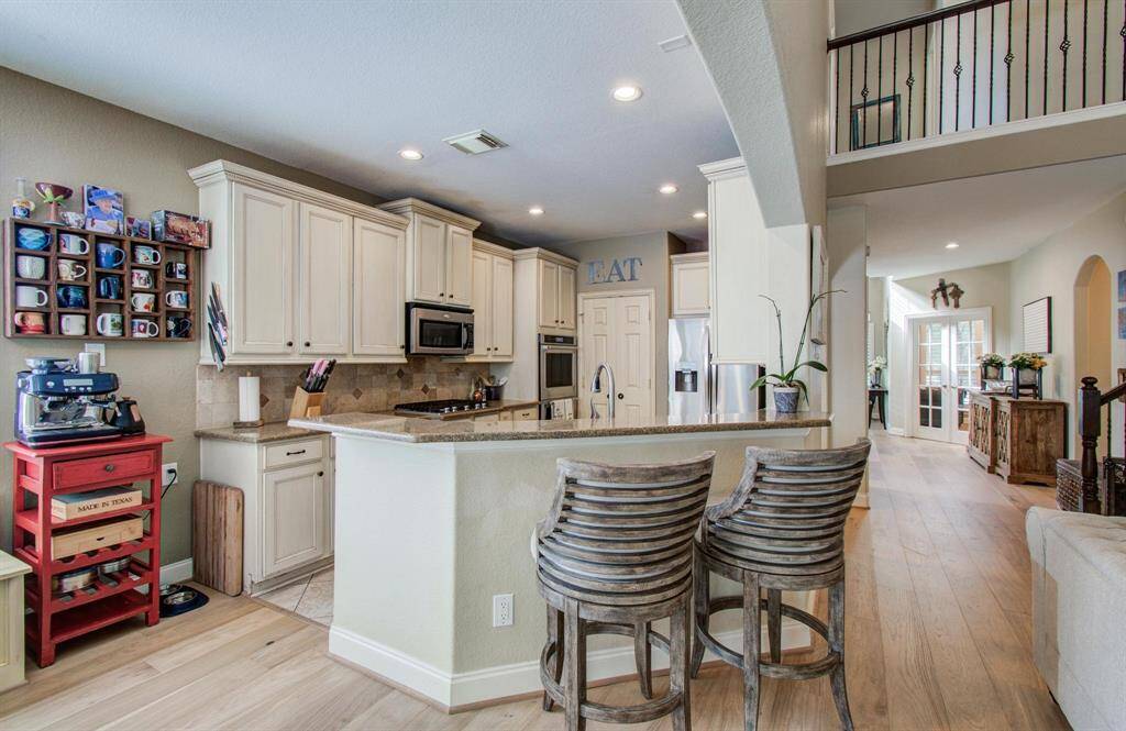 Kitchen open to the family room, with plenty of cabinet and counter space.