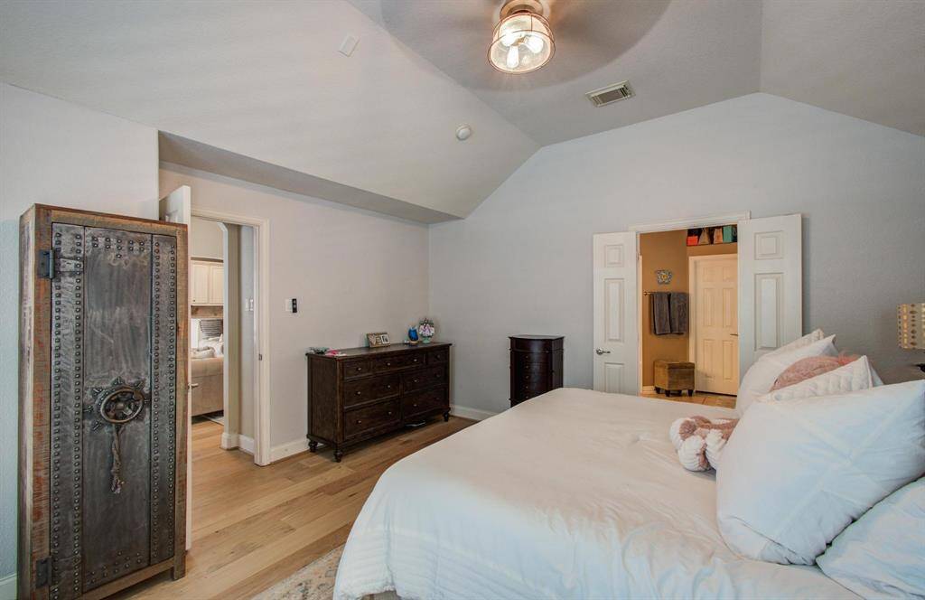 Primary bedroom with high ceilings and tons of natural light with views of your backyard oasis.