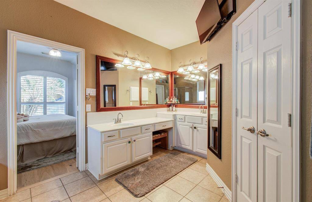 Double sinks and plenty of cabinet space in the primary bath.