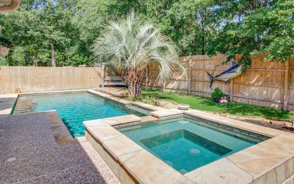 Enjoy a shaded covered patio space with pool views and privacy.