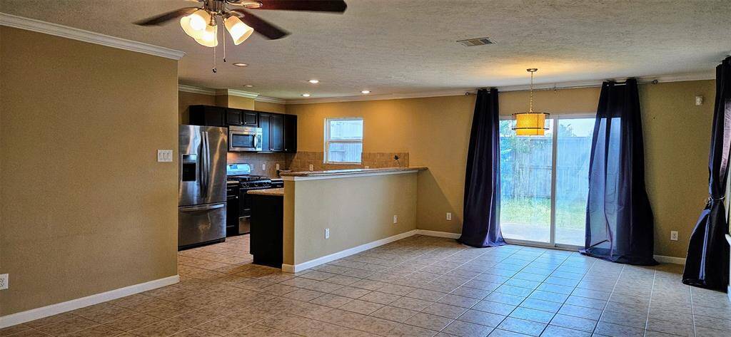 FROM ENTRY LOOKING TO FAMILY ROOM AND DINING AREA KITCHEN