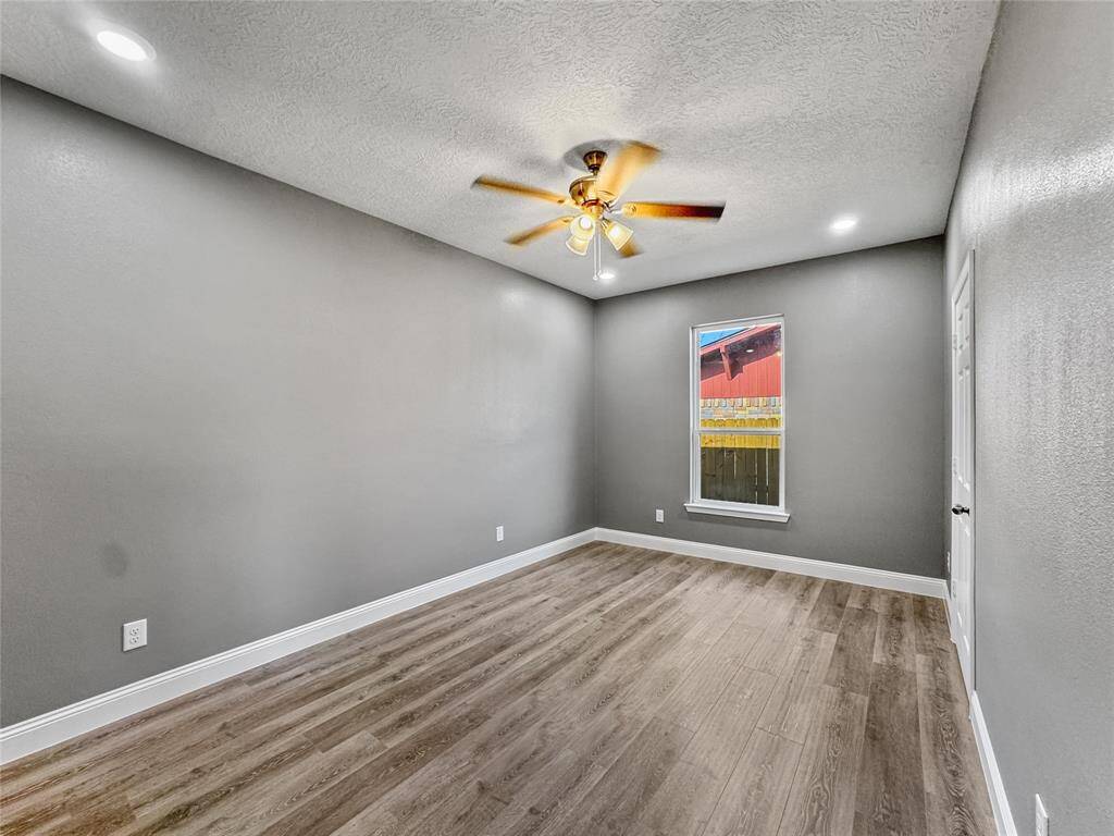 Second bedroom bedroom includes ceiling fan and recessed lighting and lots of natural light.