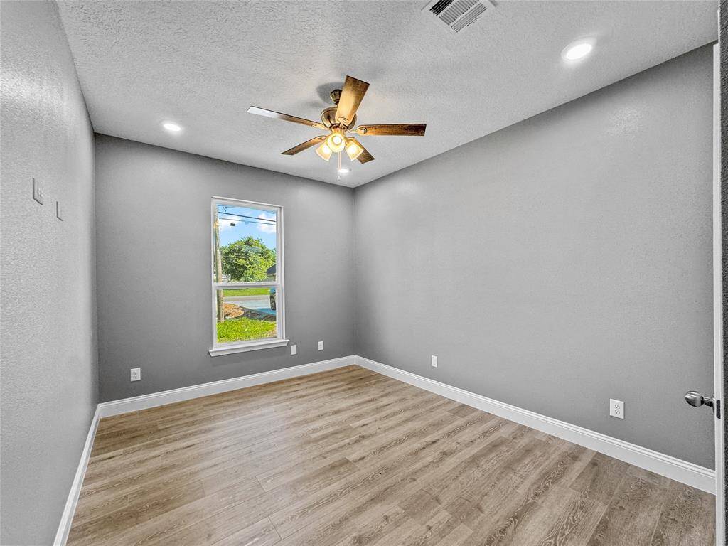 Fourth bedroom includes ceiling fan and recessed lighting and lots of natural light.