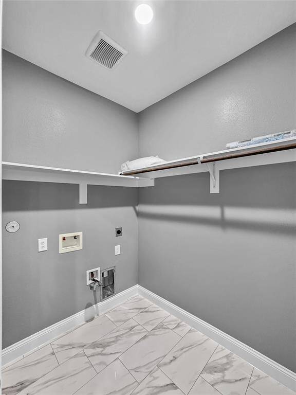Utility room conveniently located in the house and near kitchen with plenty of room for laundry baskets. Lots of overhead storage with direct access to garage.