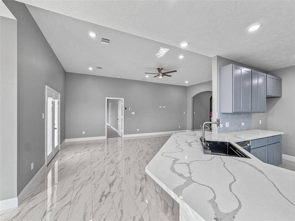 The view from your open concept dining area. Quartz countertops continue over on this wrap around breakfast island. Perfect for the little ones or entertaining.