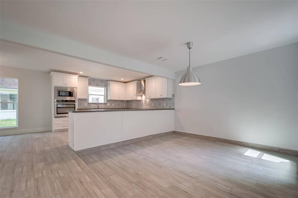Another view of the dinning room-kitchen combination, with massive convenient countertop space.