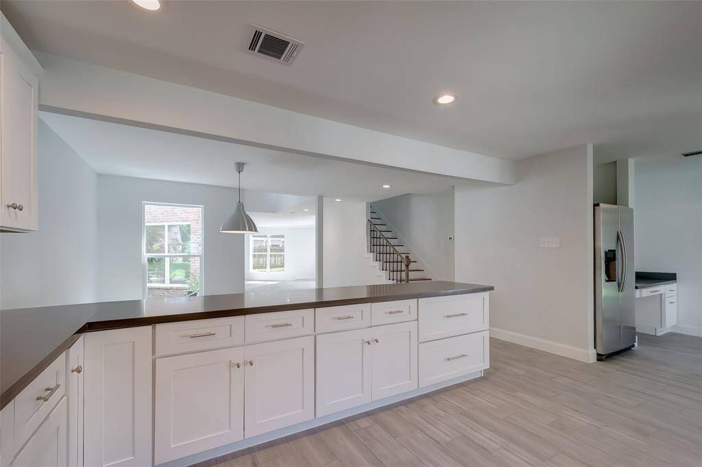 First view from the kitchen with tons of cabinet and countertop space.