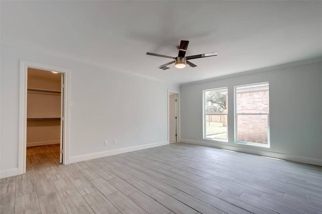 Bright master bedroom with view to the backyard.