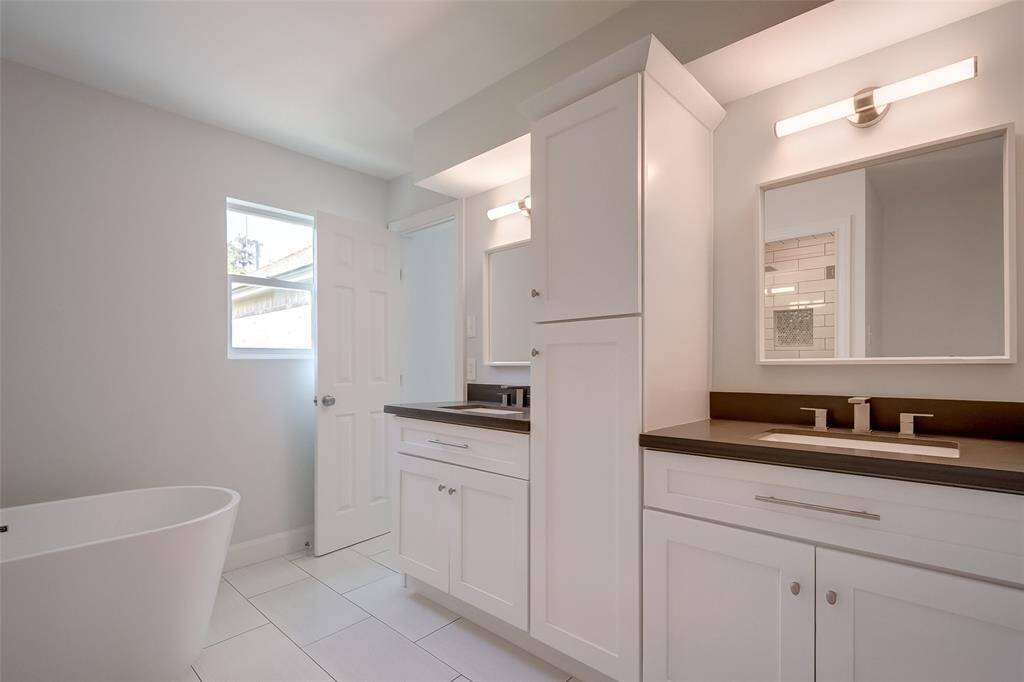 Clean and modern master bathroom with double sinks and lots of storage space.