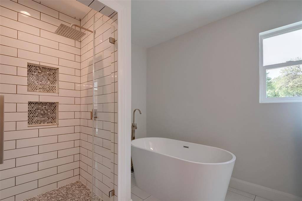 Spectacular dazzling stand up shower separate free standing tub.