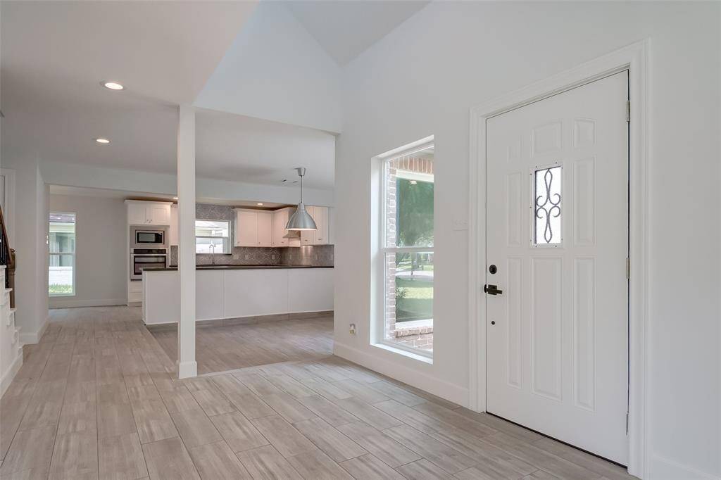 Bright open entrance with exquisite wood-like tile floor throughout the 1st floor.