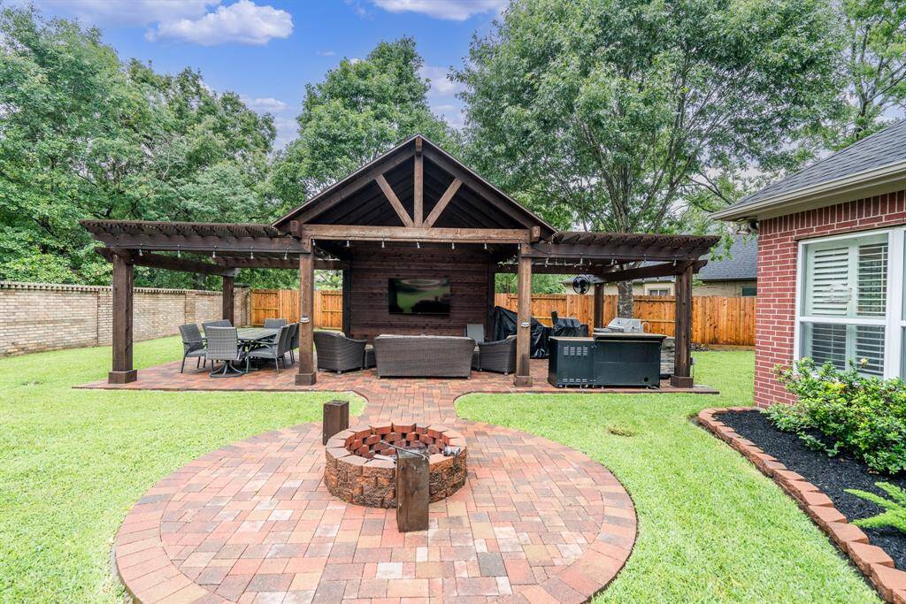 Pavilion with large seating area and enough space for outdoor kitchen, grill and spot for TV.