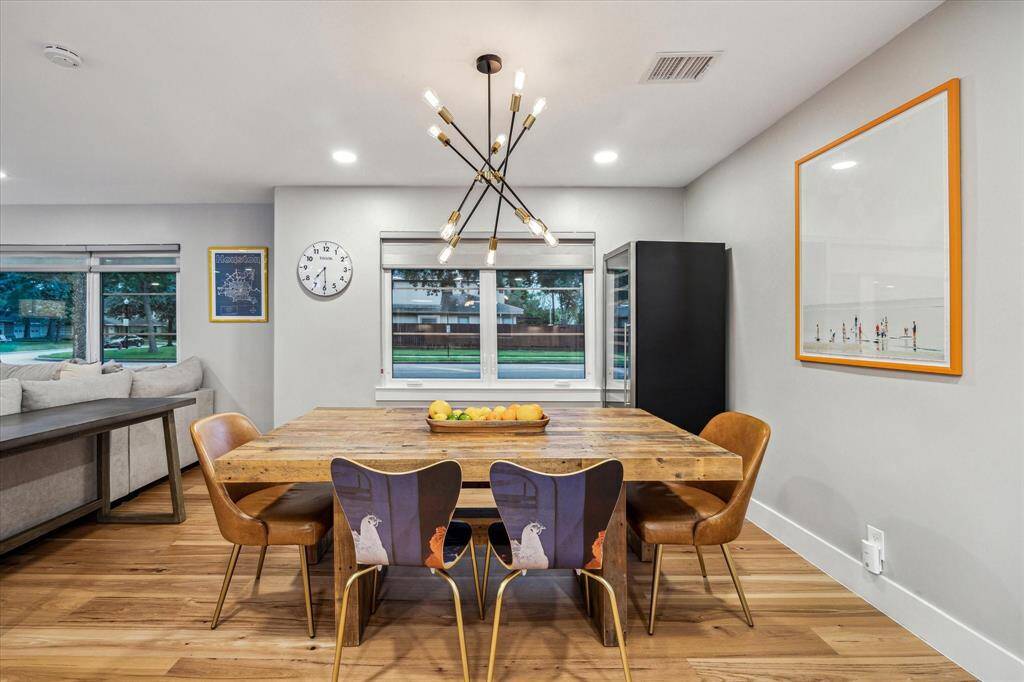 Experience a stylish open layout featuring a nice dining area with recessed lighting, a modern fixture, and a wine chiller included.