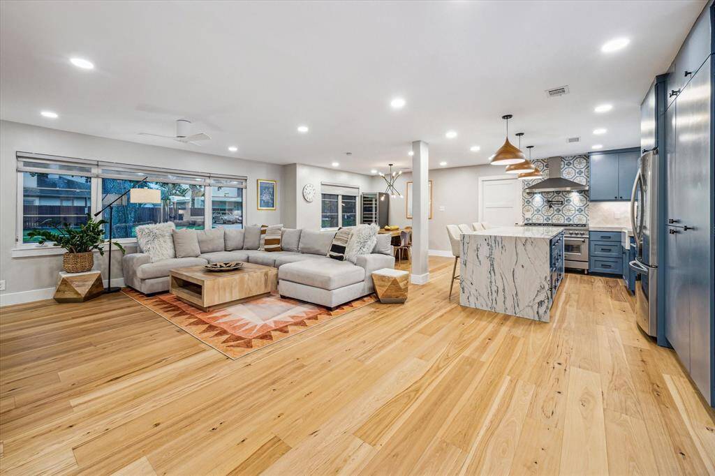 Living area with spacious open concept, gorgeous hardwoods,  and an abundance of natural light creating a warm, inviting atmosphere.