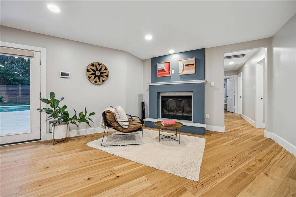 Inviting living space with a wood-burning fireplace, ideal for a cozy seating area or flexible space.
