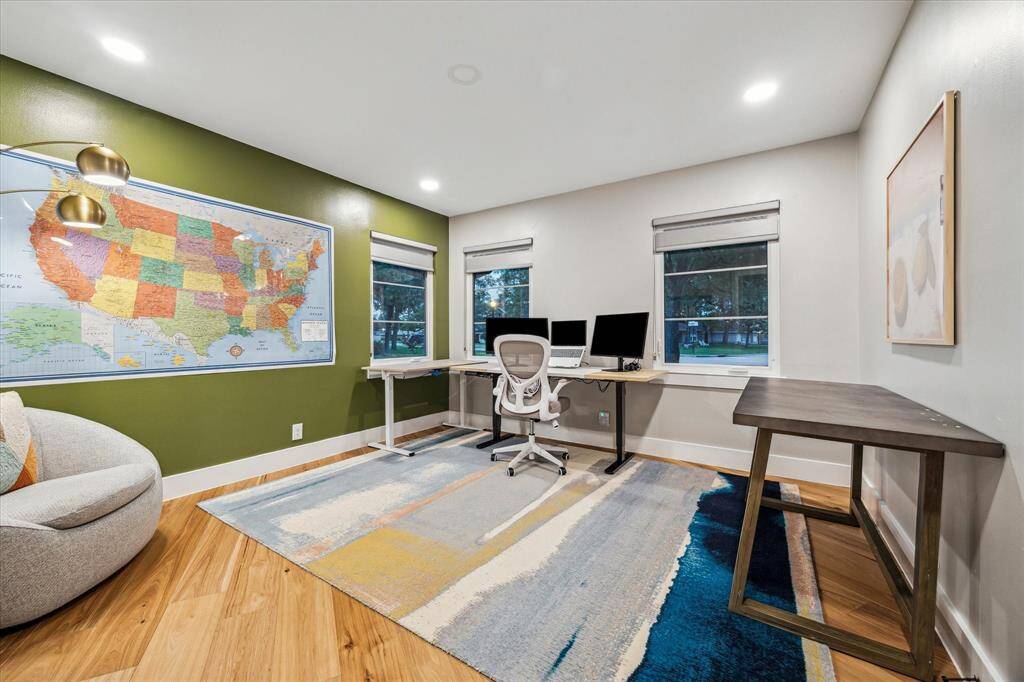 One of the bedrooms currently used for home office with great corner windows for natural lighting.