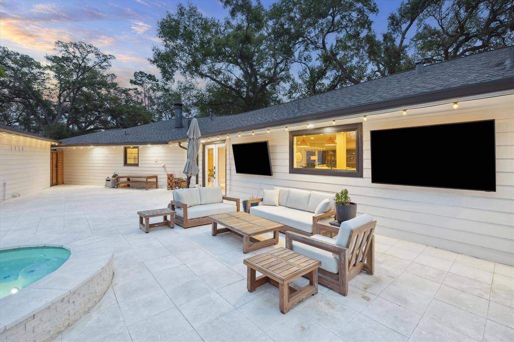 Discover the ultimate backyard retreat featuring a spacious stone patio perfect for lounging and entertaining. Enjoy movie nights and games with two Samsung Terrace outdoor TVs and surround sound speakers.