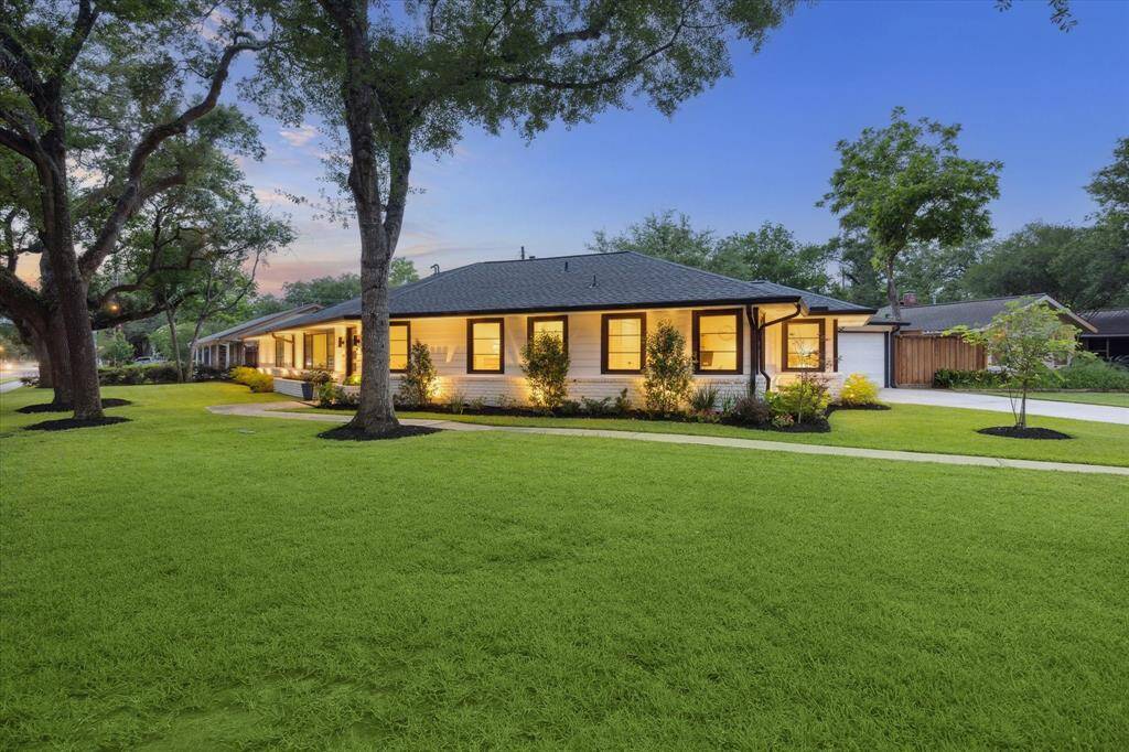 Gorgeous landscaping and warmly lit exterior with outdoor lighting including the perimeter, backyard, and front yard with moon lights.