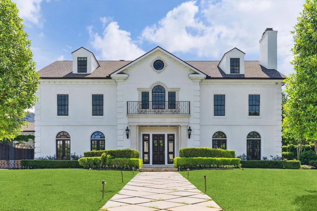 Stately Tanglewood residence sits on 18,870 sq. ft. Limestone surrounds door, circular patterned concrete driveway, double wrought iron gates allow access to porte cochere and ample parking. Two attached garages hold 5 cars.