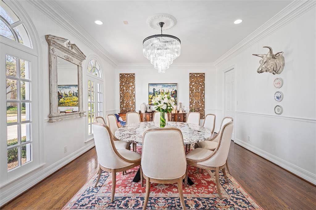 Formal dining room with abundant natural light that features arched windows and beautiful crown molding. Opens to kitchen through Butlers Pantry, which includes a china and silver storage closet