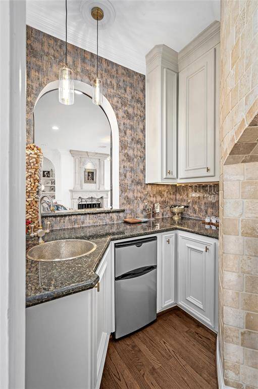 Beautiful wet bar that opens to formal living room and family room