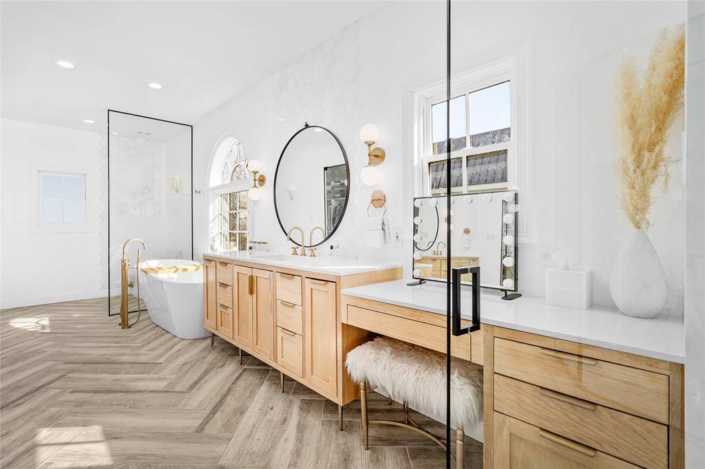 Primary bathroom oasis with heated floors, glass door entry, double vanity areas, soaking tub, and large separate shower, and abundant storage.