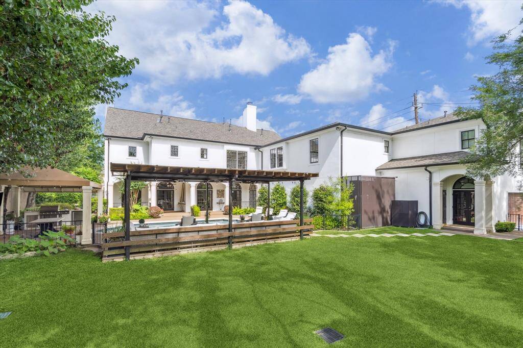 Large backyard green space beyond the pool