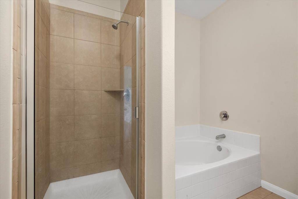 Primary bathroom with separate tub and shower.