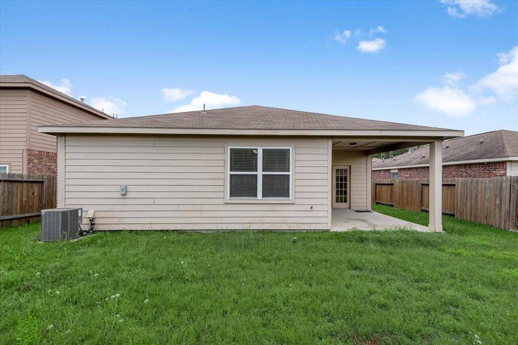 Large back yard with covered patio.