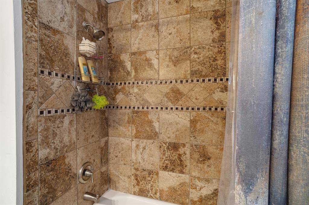 The custom tiled shower/tub was updated