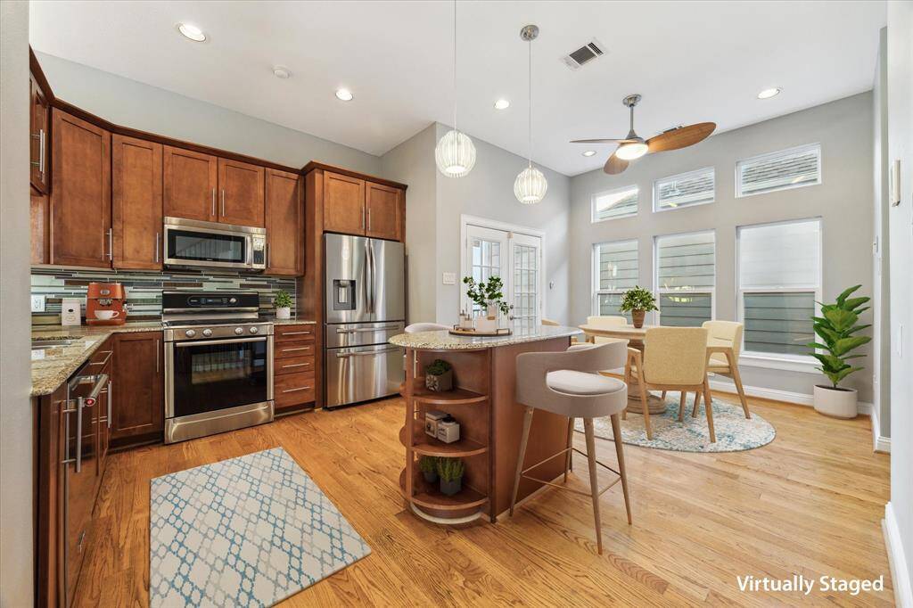 Second floor: The stunning kitchen flows seamlessly into a bright breakfast area, while double doors open to a private, covered balcony—perfect for morning coffee or evening unwinding.