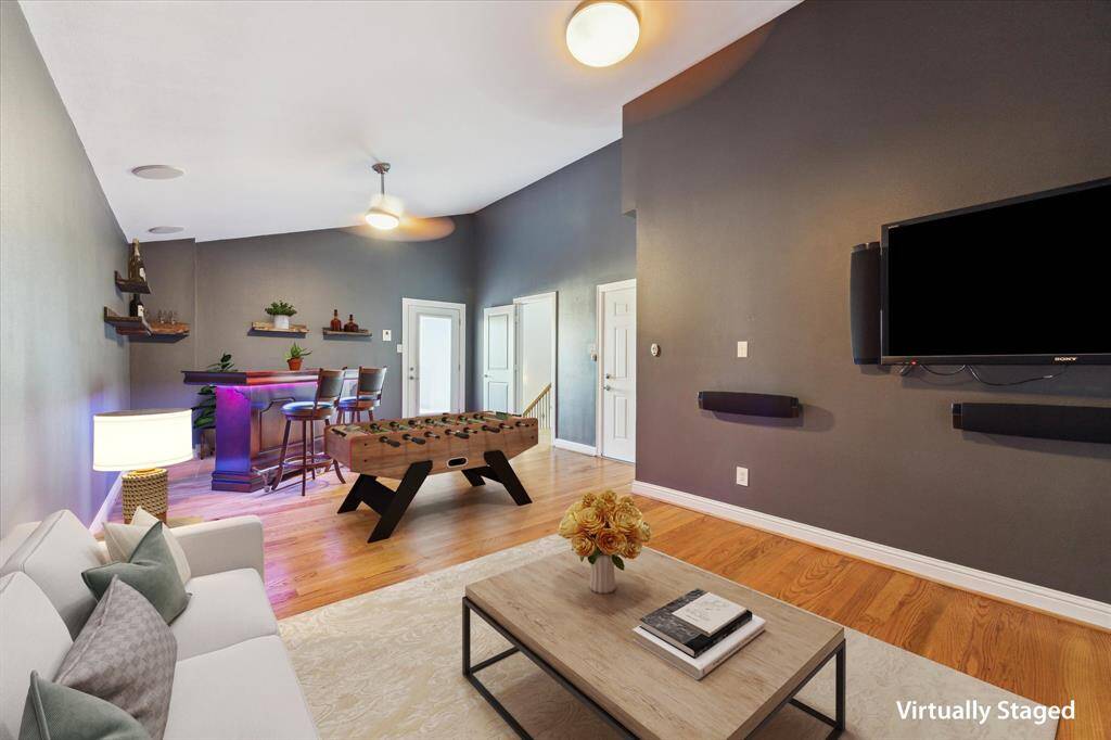 Fourth floor: The spacious game room features a dedicated movie area enhanced by additional built-in speakers, creating an immersive home theater experience perfect for movie nights or game days.